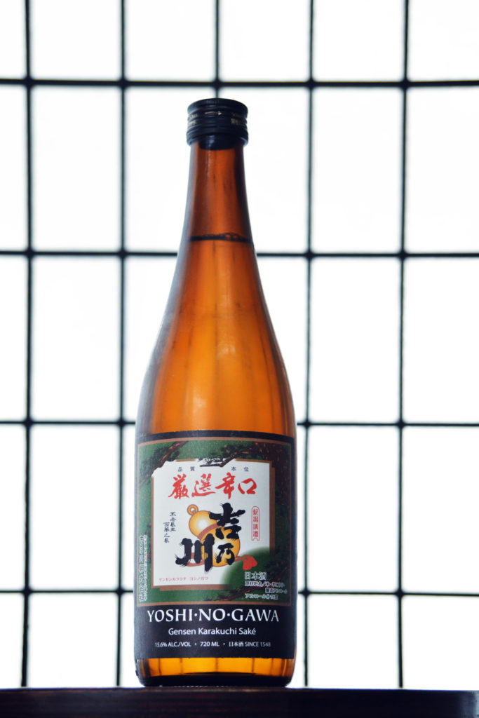 a bottle of sake with a black and white backdrop