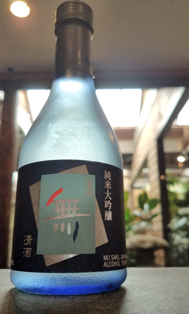 a bottle of sake in a modern bar