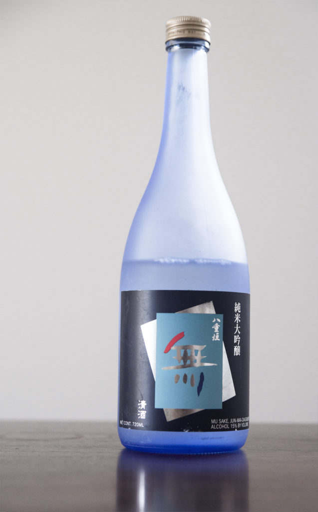 a bottle of sake on a wooden table