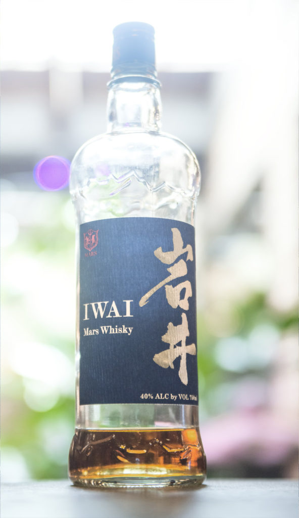 An almost empty bottle of Mars Iwai Whisky.
